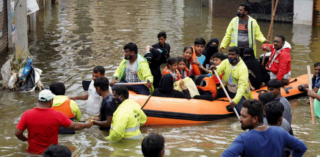 Residents are evacuated from a flooded neighbourhood after heavy rainfall in Hyderabad, the capital of the southern state of Telangana, India, October 15, 2020. Credit: Reuters Photo