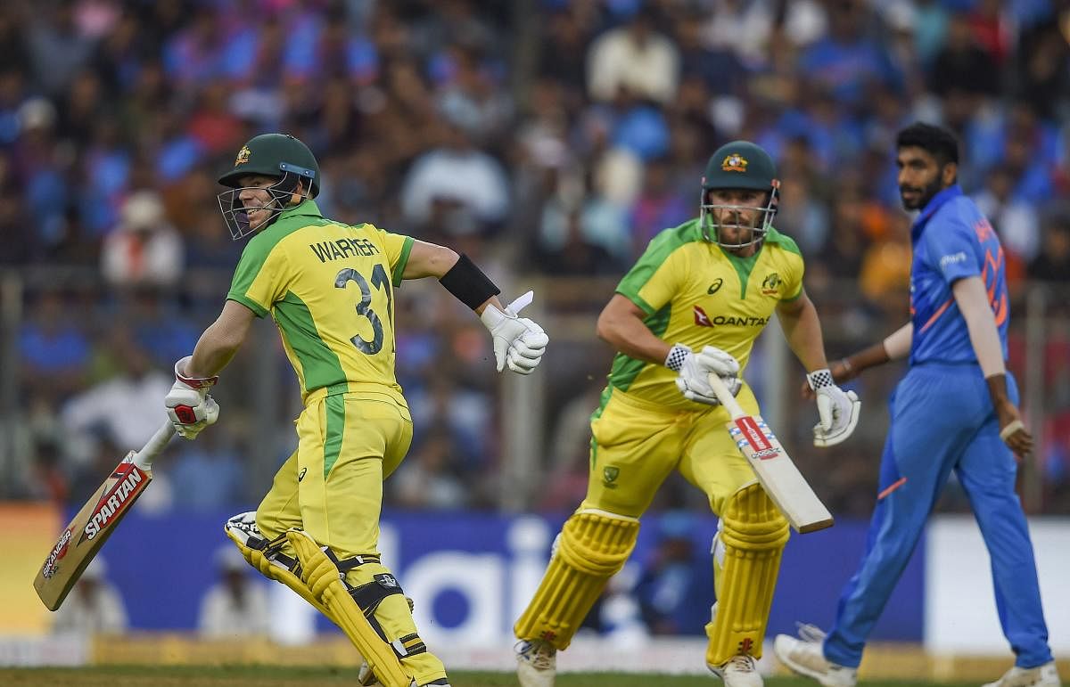 Australian batsmen Aaron Finch and David Warner run between the wickets during the first one day international (ODI) cricket match against India, at the Wankhede Stadium in Mumbai. (PTI Photo/Kunal Patil)