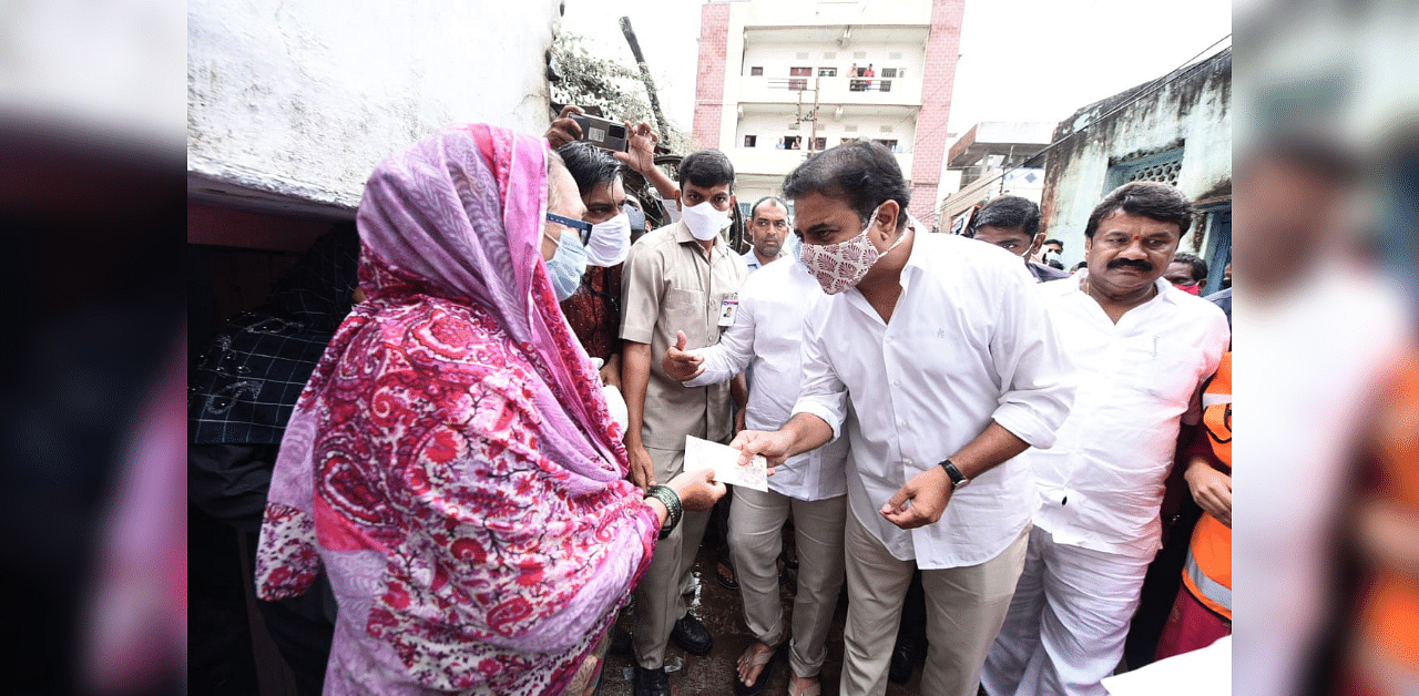 Municipal Administration and Urban Development Minister KT Rama Rao visited MJ Colony in Shaikpet and Nadeem Colony in Tolichowki and other localities and handed over Rs 10, 000 to the rain-affected families. Credit: DH Photo (By Special Arrangement)