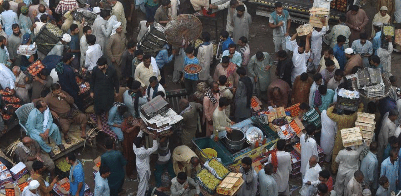 Traders and buyers gather at a fruit market in Lahore on September 27, 2020. Credit: AFP Photo