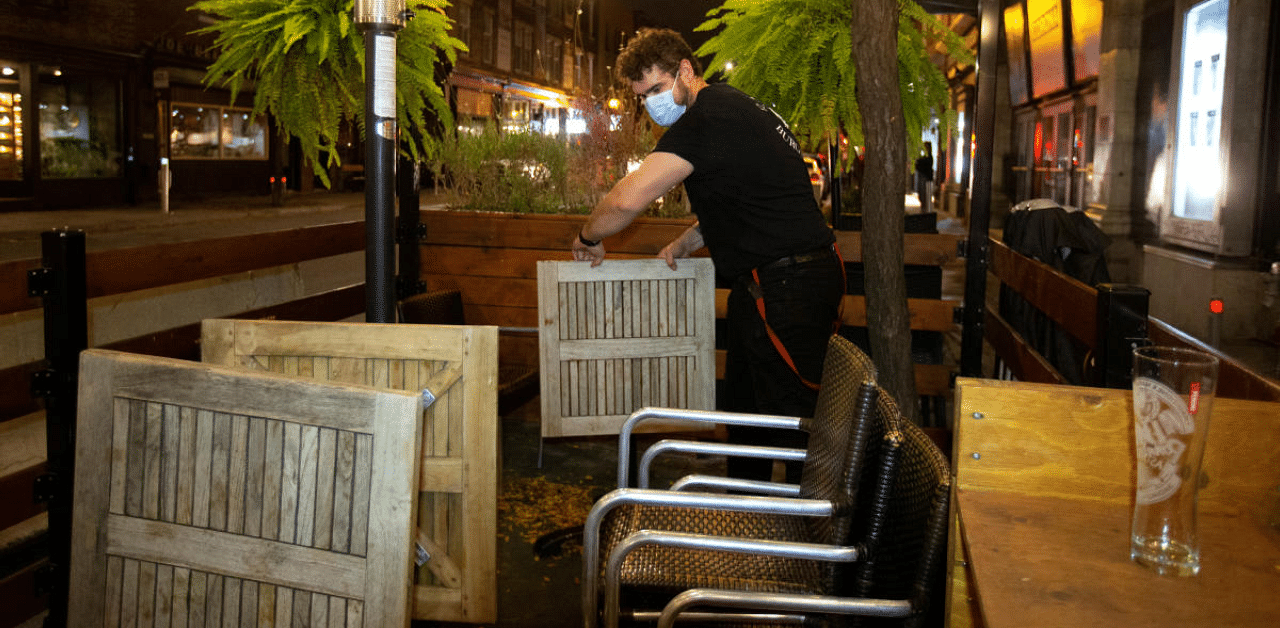 An employee dismantles the terrasse at closing time as the Quebec government has ordered all restaurants, bars and casinos to close for 28 days effective midnight September 30 as coronavirus disease (COVID-19) numbers continue to rise in Montreal, Quebec, Canada. Credit: Reuters Photo