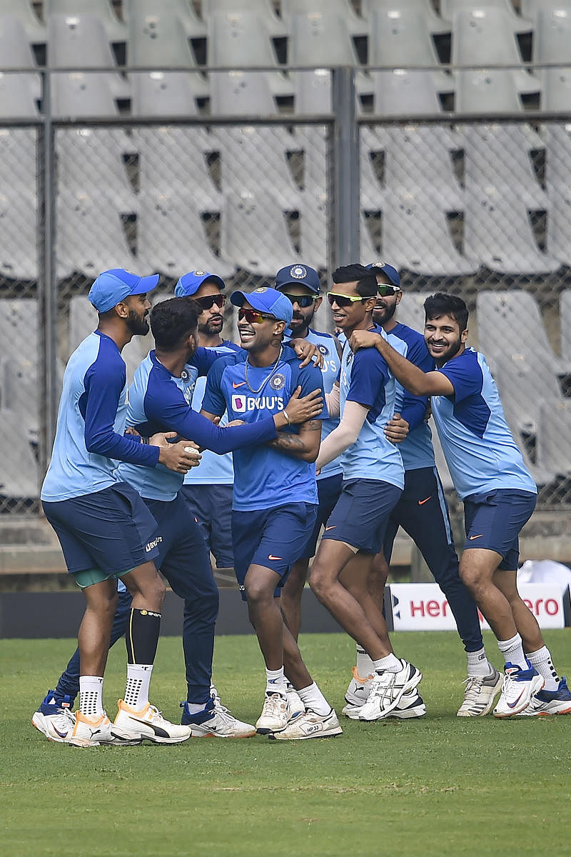 Team-mates share a light moment with Hardik Pandya who joined the Indian team's training session ahead of the first ODI against Australia at the Wankhede Stadium in Mumbai on Monday. PTI