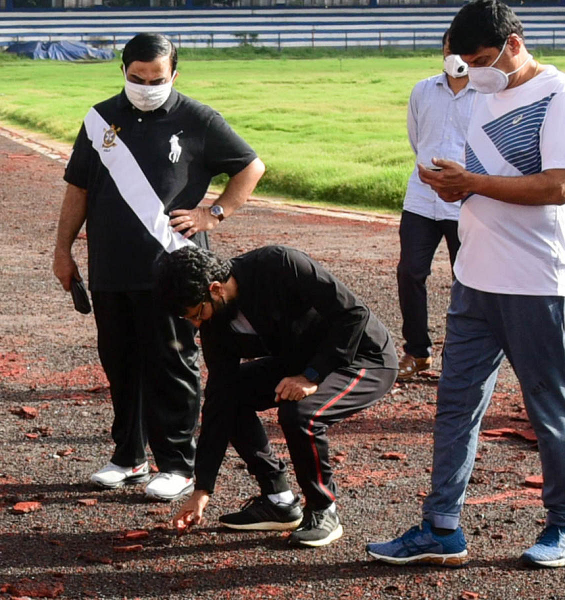 Youth Empowerment and Sports Minister C T Ravi inspects the track work at the Sree Kanteerava Stadium as Karnataka Olympic Association President K Govindraj (left) looks on. The minister visited the stadium to take part in the symbolic Olympic Run on Tuesday. DH Photo/ B H Shivakumar