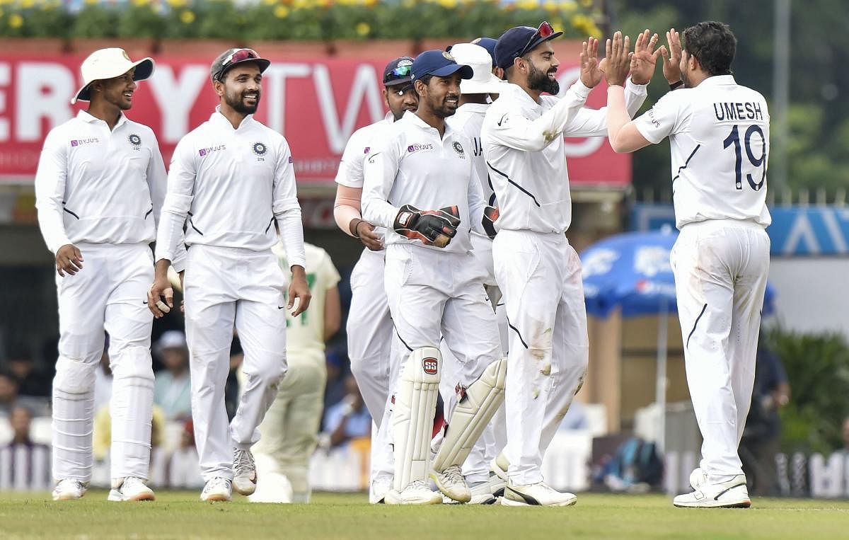 Indian bowler Umesh Yadav with captain Virat Kohli and other teammates celebrates the dismissal of South African batsman George Linde during day 3 of the 3rd cricket test match at JSCA Stadium in Ranchi, Monday, Oct. 21, 2019. (PTI Photo/Ashok Bhaumik) 