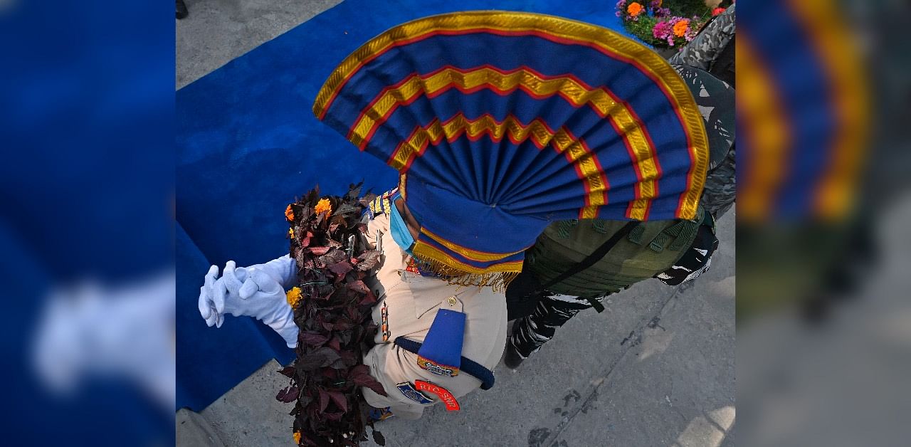 An Indian Central Reserve Police Force (CRPF) personnel carries a wreath during a wreath laying ceremony for a slain Assistant Subinspector, who died during an attack by suspected militants in Chadoora area of Budgam district, at the CRPF headquarters in Srinagar on September 24, 2020. Credit: AFP