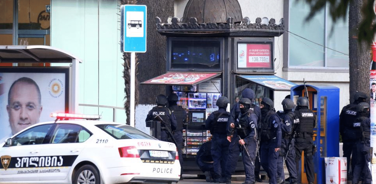 Law enforcement officers are seen near a bank branch after an unidentified man reportedly took hostages, in the western Georgian city of Zugdidi on October 21, 2020. Credit: AFP Photo