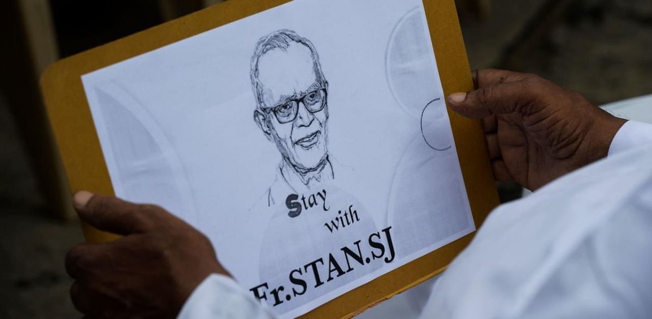 A Catholic priest holds a placard with the immage of Jesuit priest Father Stan Swamy during a protest against his arrest in the eastern Indian state of Jharkhand for his alleged involvement in Bhima Koregao-Elgar Parishad case. Credit: AFP