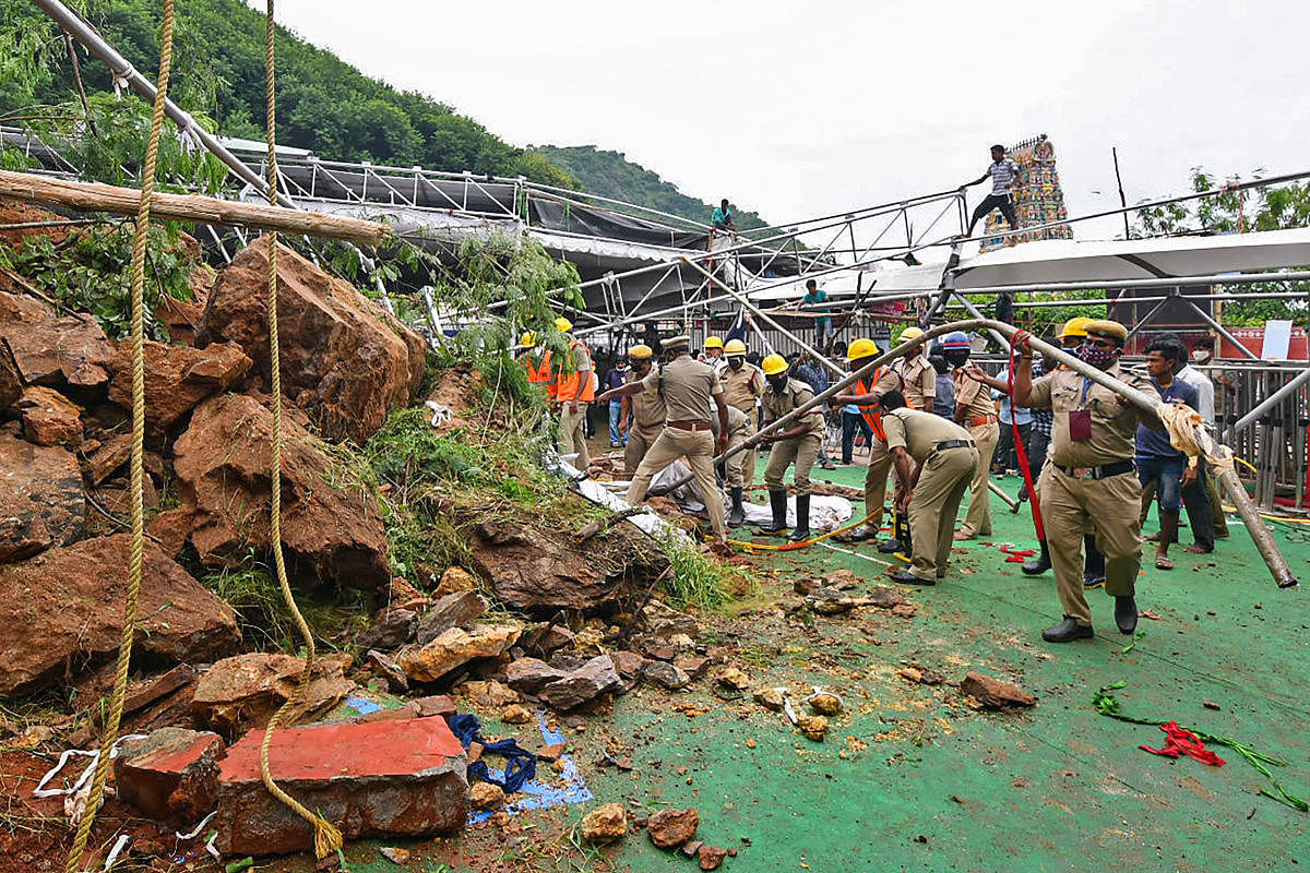  Police personnel clear the debris after a landslide on the hilltop of Kanaka Durga temple, in Vijayawada, Wednesday, Oct. 21, 2020. Credit: PTI Photo