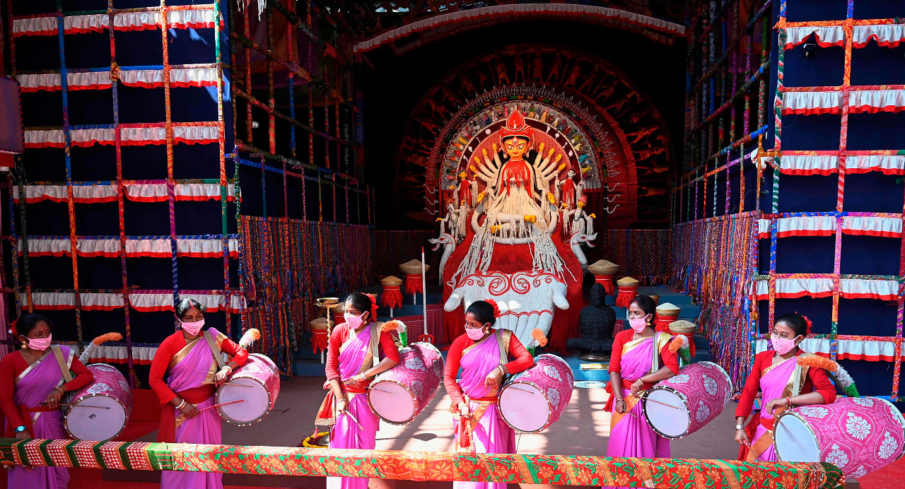 Traditional drummers play perform near an idol of the ten-armed Hindu Goddess Durga at a makeshift place for worship ahead of the Hindu festival 'Durga Puja' in Kolkata on October 20, 2020. Credit: AFP Photo