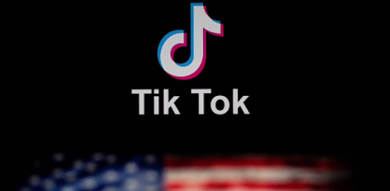Logo of the social network application TikTok and a US flag. Credit: AFP Photo