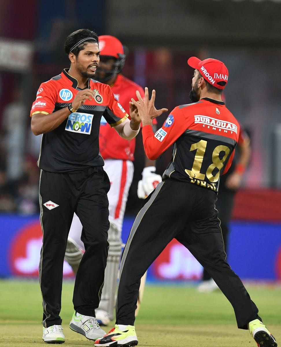  Royal Challengers Bangalore's paceman Umesh Yadav (left) celebrates with skipper Virat Kohli after dismissing Kings XI Punjab's KL Rahul. 