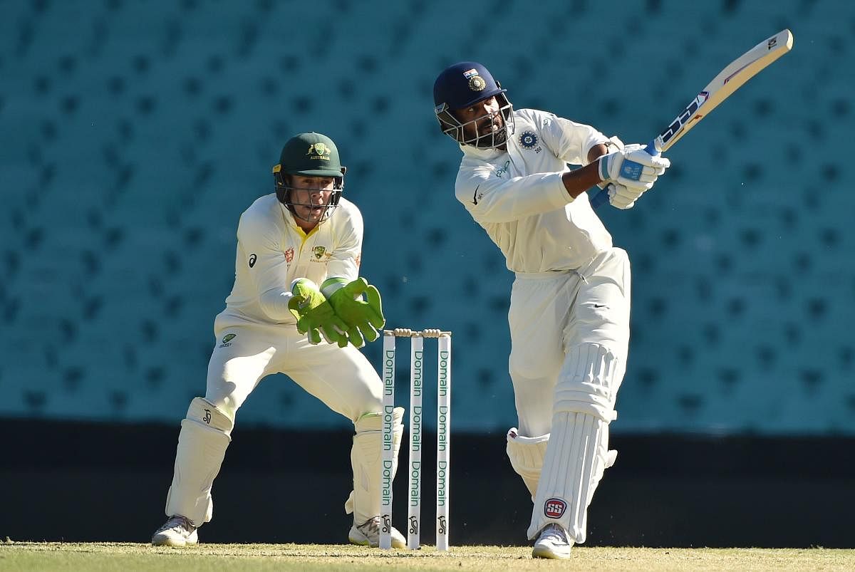 Murali Vijay hits a shot on the fourth day of the tour match against Cricket Australia XI at the SCG in Sydney. AFP Photo 
