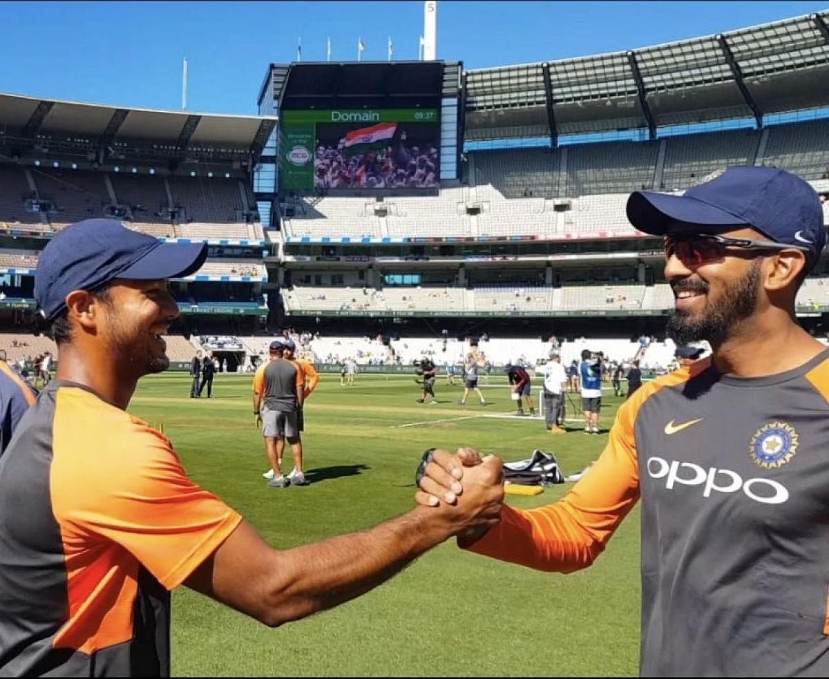 KL Rahul congratulates Karnataka and India teammate Mayank Agarwal after the latter received the Test cap from skipper Virat Kohli in Melbourne on Wednesday.