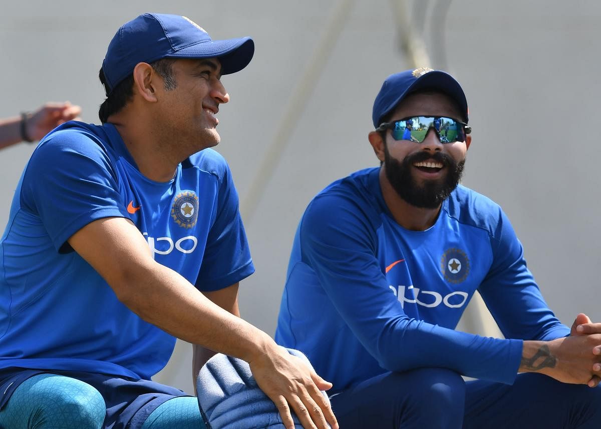IN RELAXING MOOD: Mahendra Singh Dhoni (left) and Ravindra Jadeja share a light moment during during India's training session at the VCA Stadium in Nagpur on Monday. AFP