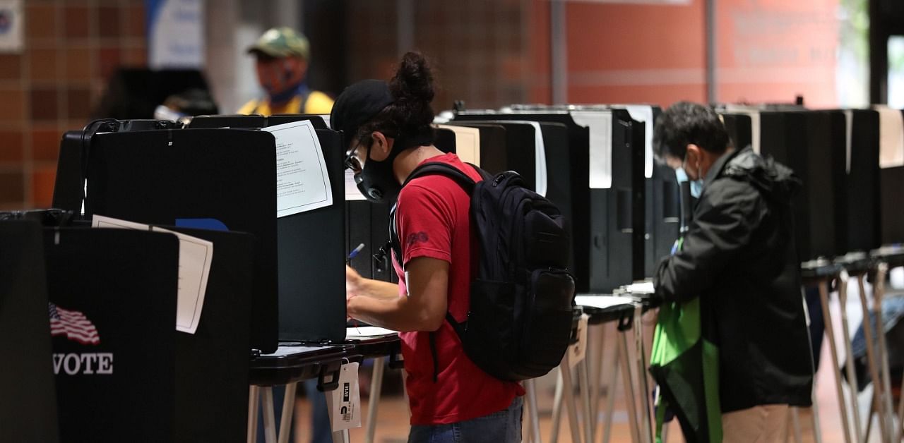 Voters fill out their ballots as they vote at the Stephen P. Clark Government Center polling station. Credit: AFP Photo