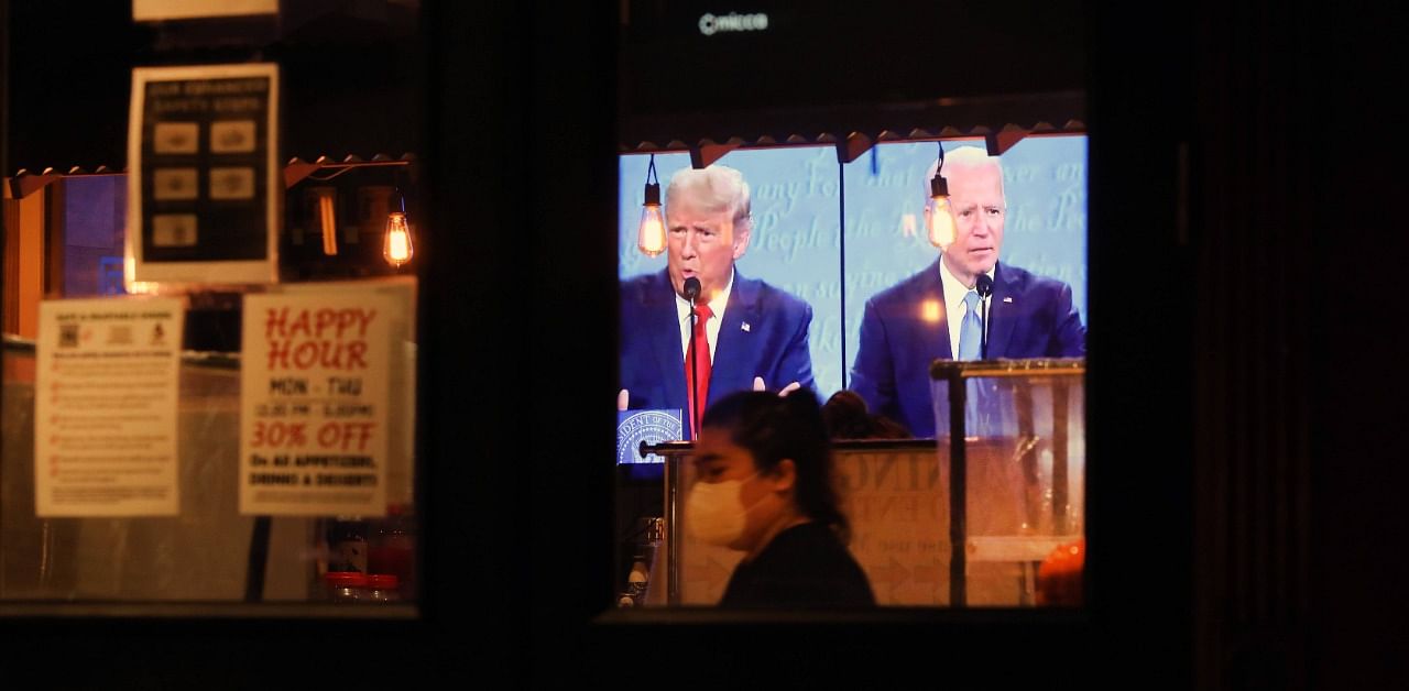 The final debate between President Donald Trump and Joe Biden plays on a restaurant television in Manhattan. Credit: AFP Photo