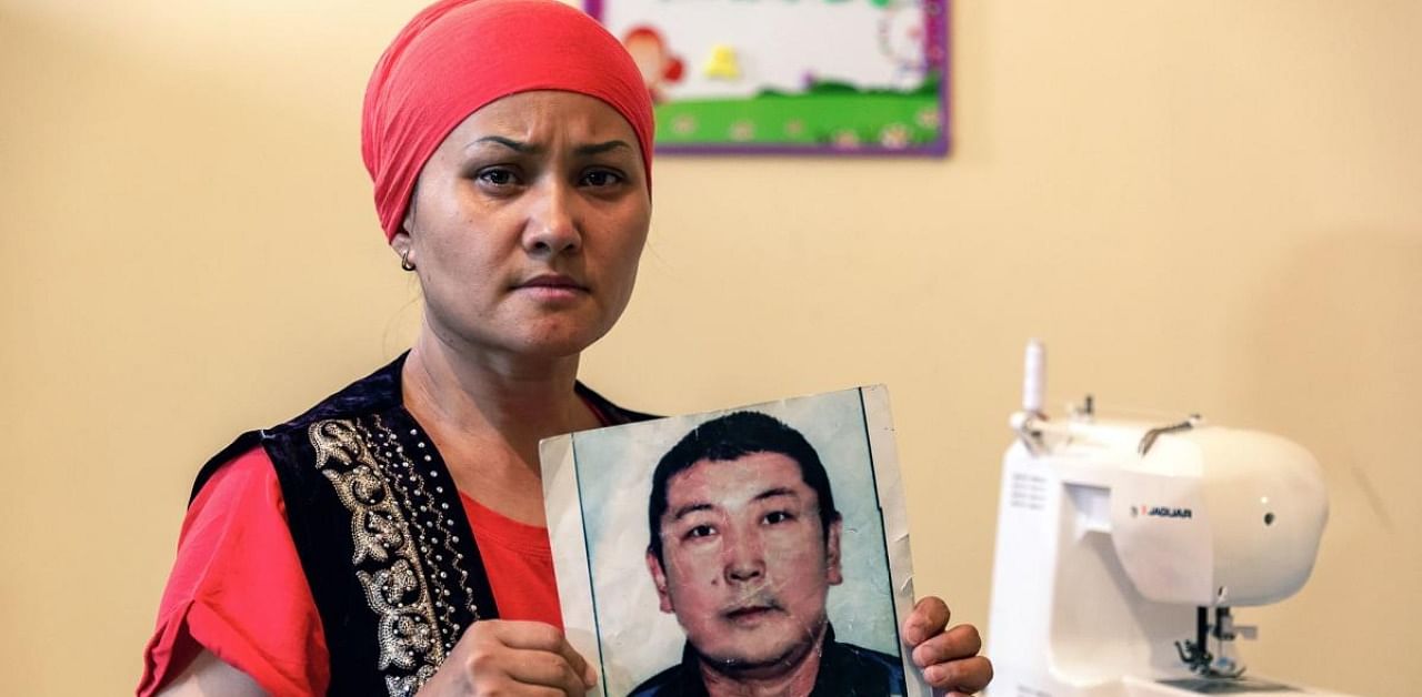  Bikamal Kaken with a picture of her husband. Credit: AFP Photo