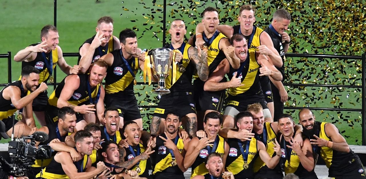 Richmond Tigers players celebrate with the trophy after winning the AFL Grand Final. Credit: Reuters