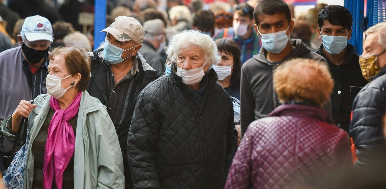 People wear face masks as they shop groceries in Sofia's largest outdoor groceries market in Sofia. Credit: AFP Photo