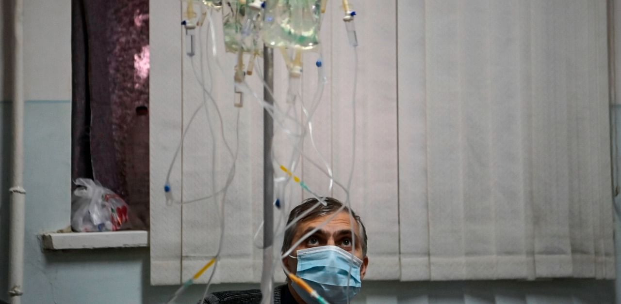  A man looks at IV lines as patients that are suspected cases of the novel coronavirus Covid-19 wait for treatment in a hospital of the city of Stepanakert. Credit: AFP