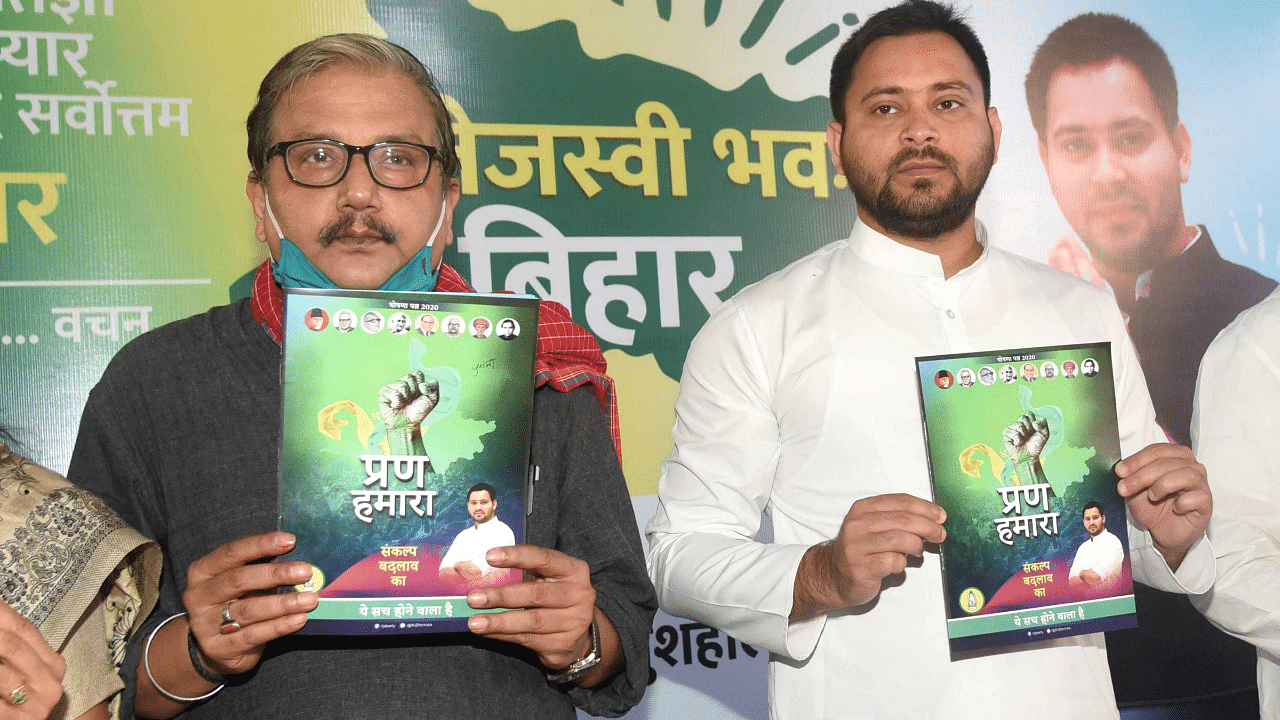  RJD leader Tejashwi Yadav with party MP Manoj Jha and others release party's manifesto 'Prann Hamara', ahead of the Bihar Assembly Elections. Credits: PTI Photo