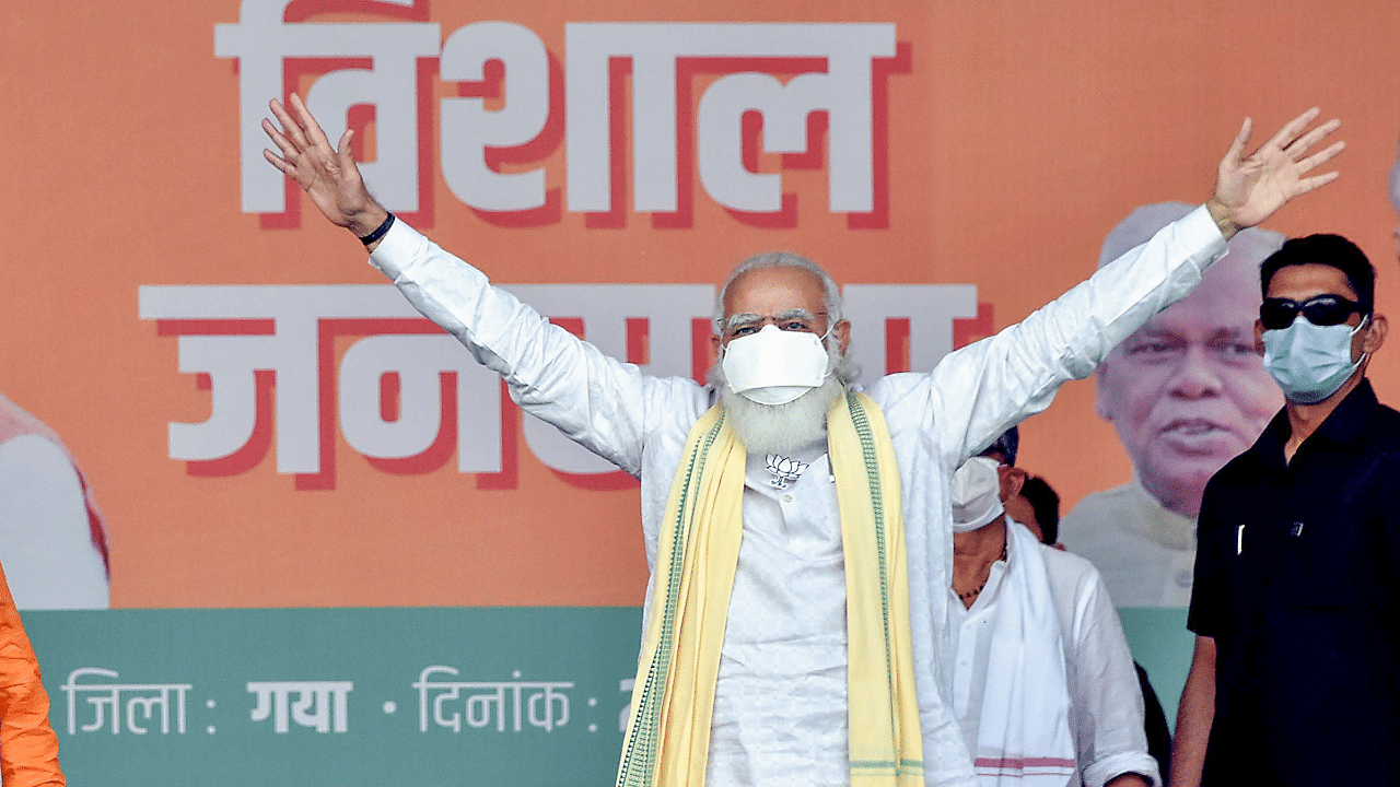 Prime Minister Narendra Modi waves at the crowd during an election rally, ahead of Bihar Assembly polls. Credits: PTI Photo