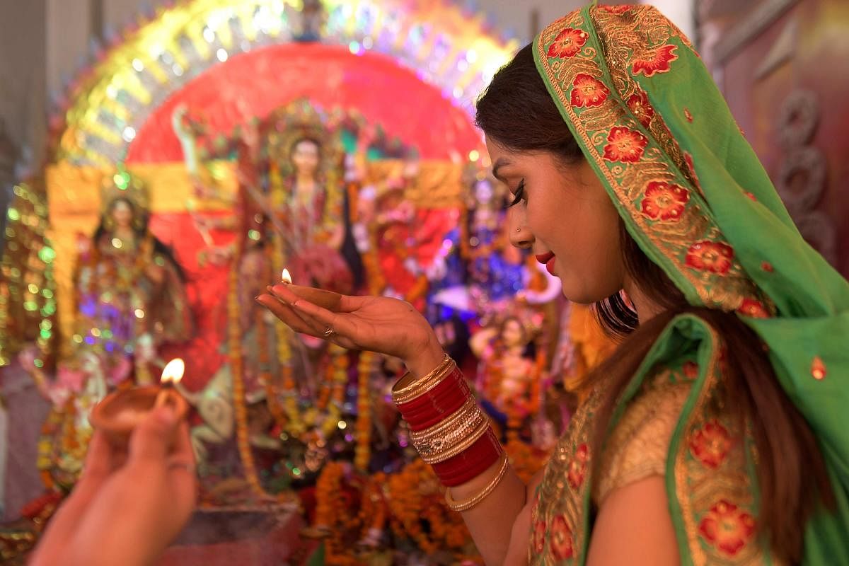 A devotee offers prayer to Goddess Durga. Credit: AFP