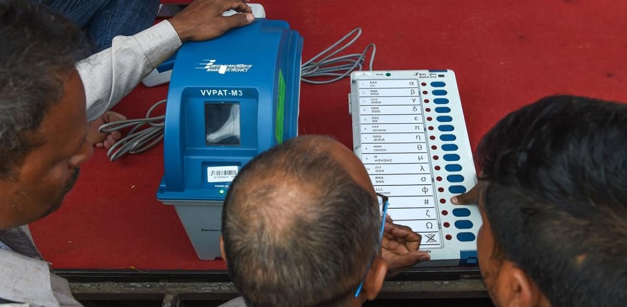 Indians try out the Electronic Voting Machine (EVM) in conjunction with the Voter-Verified Paper Audit Trail (VVPAT), a ballotless voting system, at an Election Commission demonstration. Credit: AFP