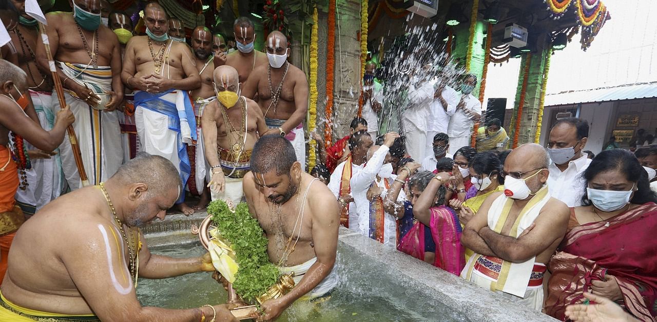Priests perform Chakrasnanam of the deity in the newly built Pushkarini inside the Srivari temple at the conclusion of Navratri Brahmotsav, in Tirupati. Credit: PTI