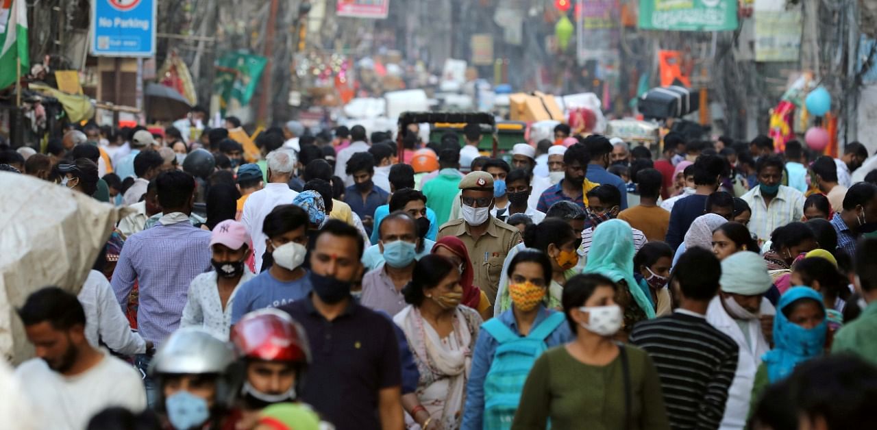 People are seen at a market amidst the spread of the coronavirus disease, in the old quarters of Delhi. Credit: Reuters Photo