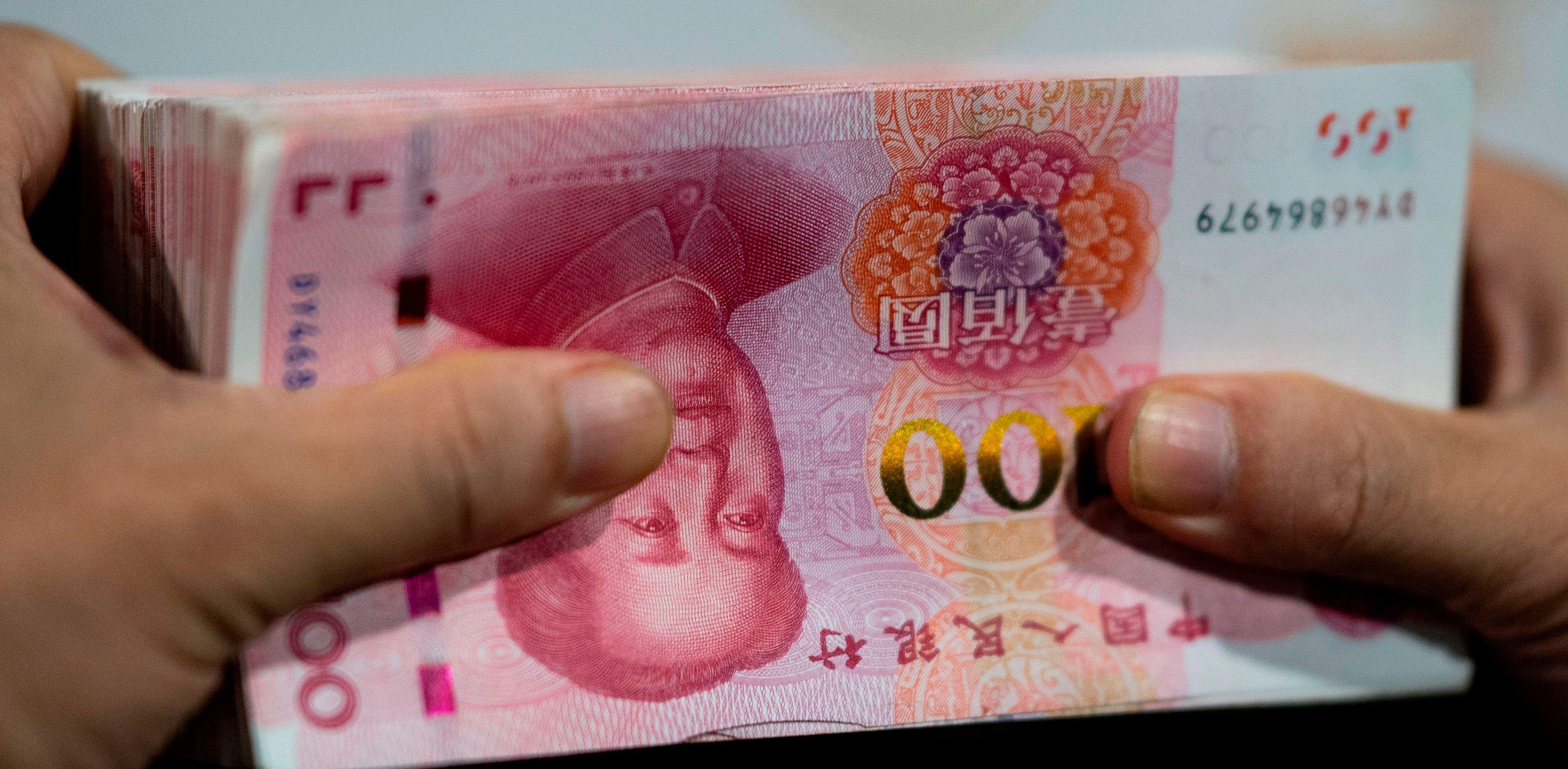 While China over the years has made some progress -- promoting offshore yuan trading, winning official reserve-currency status from the International Monetary Fund and introducing commodity contracts priced in yuan -- the yuan, also called the renminbi, is a small player on the global stage, with 2% market share. Credit: AFP