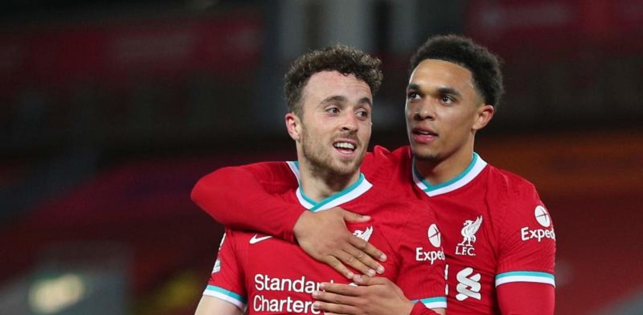 Liverpool's Portuguese striker Diogo Jota (L) celebrates scoring their second goal with Liverpool's English defender Trent Alexander-Arnold (R) during the English Premier League football match between Liverpool and Sheffield United at Anfield in Liverpool. Credit: AFP.