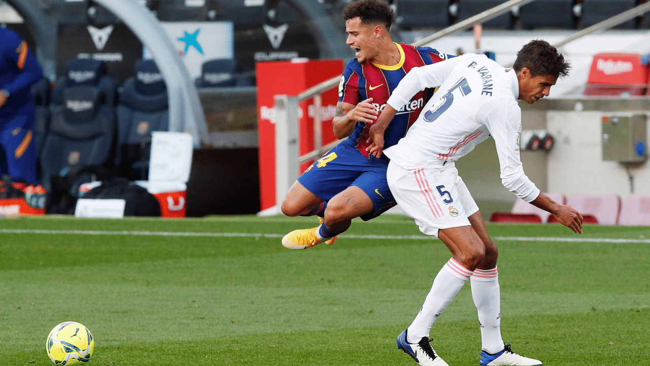Barcelona's Philippe Coutinho in action with Real Madrid's Raphael Varane. Credits: Reuters Photo