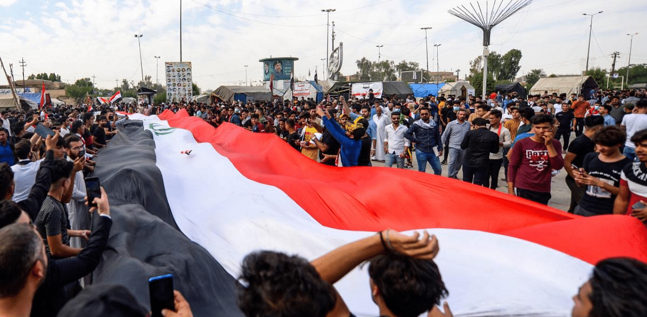 Thousands of Iraqis headed to the capital Baghdad's iconic Tahrir Square and the Green Zone, where authorities sit, to mark the first anniversary of an ongoing revolt. Credit: AFP Photo
