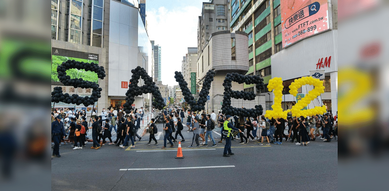 People march in support of Save12, the campaign to save twelve Hong Kong pro-democracy activists who on August 23 were caught by mainland Chinese authorities trying to flee Hong Kong to Taiwan by boat, in central Taipei on October 25, 2020. Credit: AFP Photo