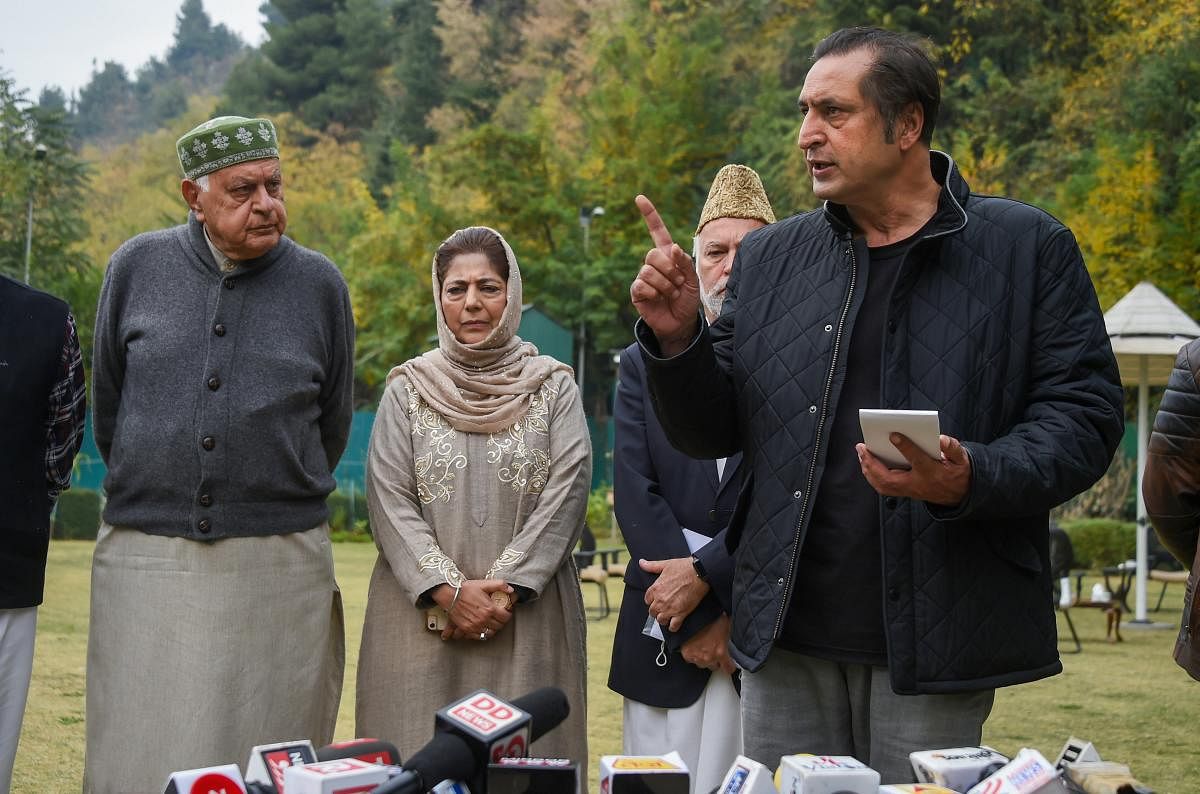 MP and President of National Conference Farooq Abdullah and PDP chief and former chief minister Mehbooba Mufti look on as People's Alliance for Gupkar Declaration spokesperson Sajjad Lone speaks to the media after a meeting of the Alliance, in Srinagar, o
