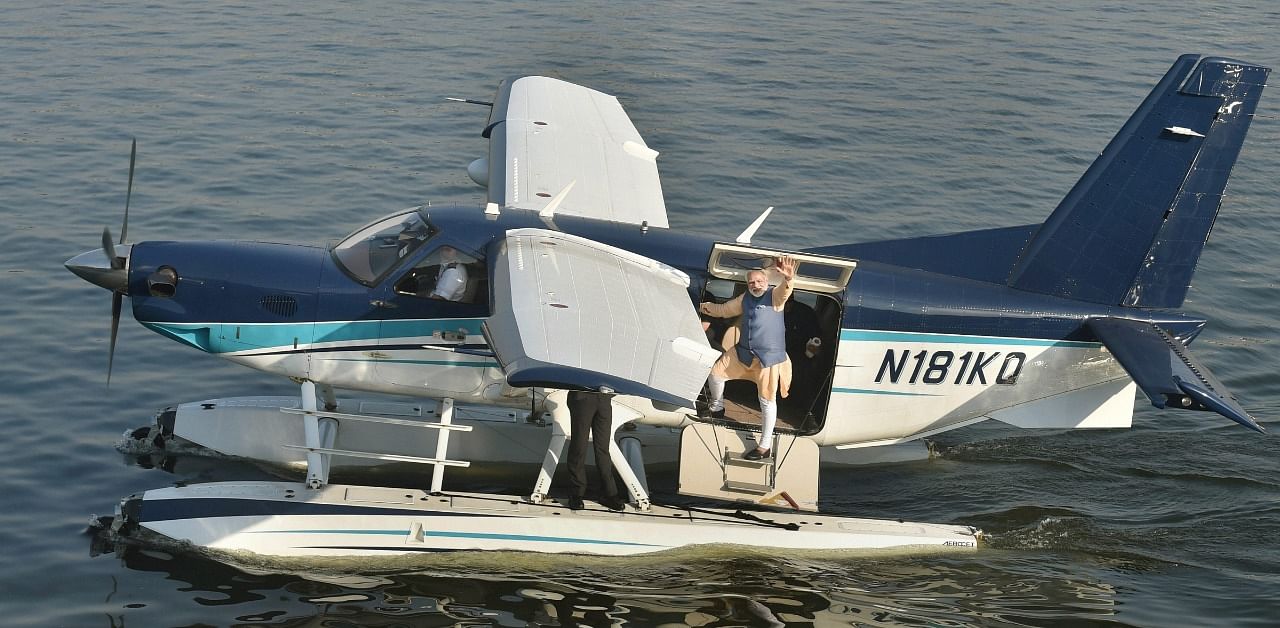 Prime Minister Narendra Modi waves to the crowd as he returns from Dharoi Dam in Mehsana district to Sabarmati riverfront by the sea-plane, in Ahmedabad. Credit: PTI Photo