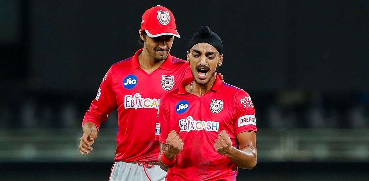 Kings XI Punjab bowler Arshdeep Singh celebrates the wicket of Mumbai Indians (MI) captain Rohit Sharma during their Indian Premier League (IPL) T20 cricket match. Credit: PTI Photo