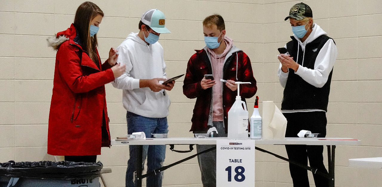 North Dakota residents prepare to self-administer COVID-19 saliva tests at a testing site inside the former Thomas Edison Elementary School, as the coronavirus disease. Credit: Reuters Photo