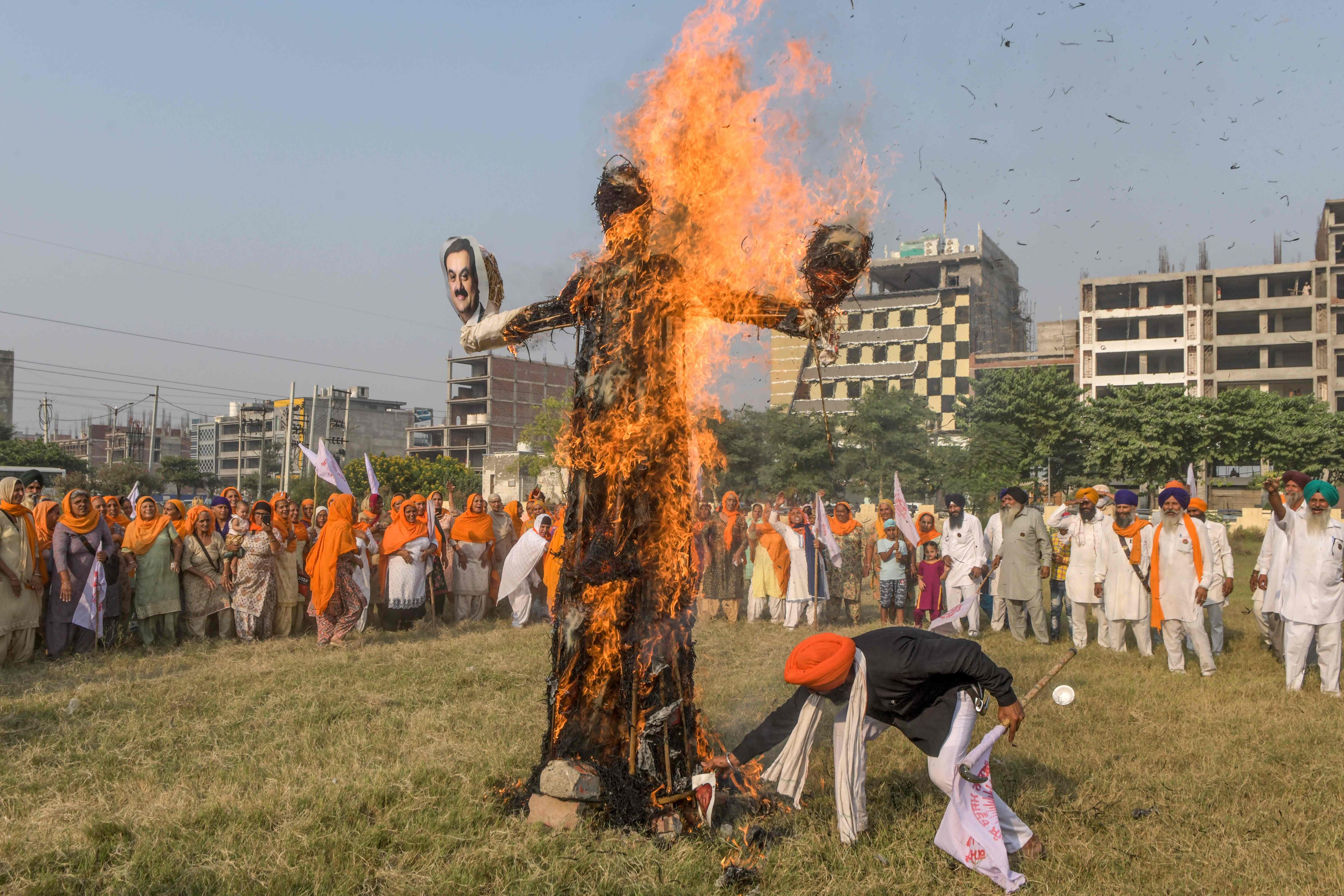 Farmers gather as they burn effigies of Prime Minister Narendra Modi. Credits: AFP Photo