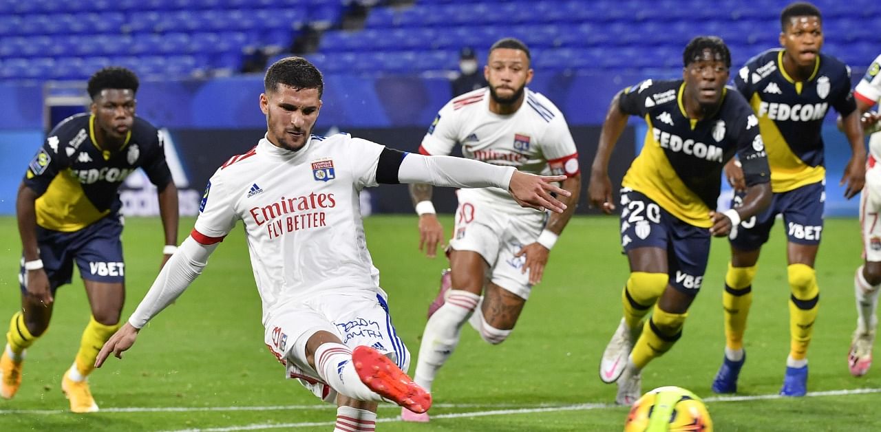 Lyon's forward Houssem Aouar scores a goal from the penalty-kick during the French L1 football match between Olympique Lyonnais (OL) and AS Monaco at the Groupama stadium in Decines-Charpieu. Credit: AFP Photo