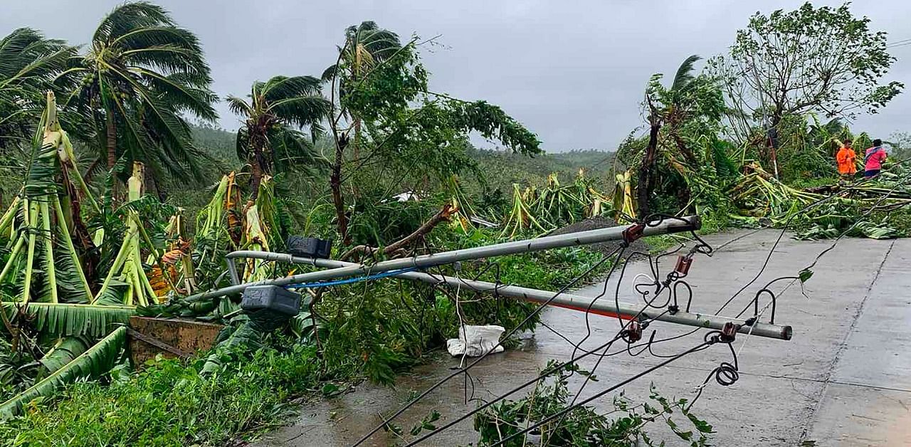 A fallen electric post blocks a road after tropical storm Molave hit the town of Pola, Oriental Mindoro province. Credit: AFP Photo