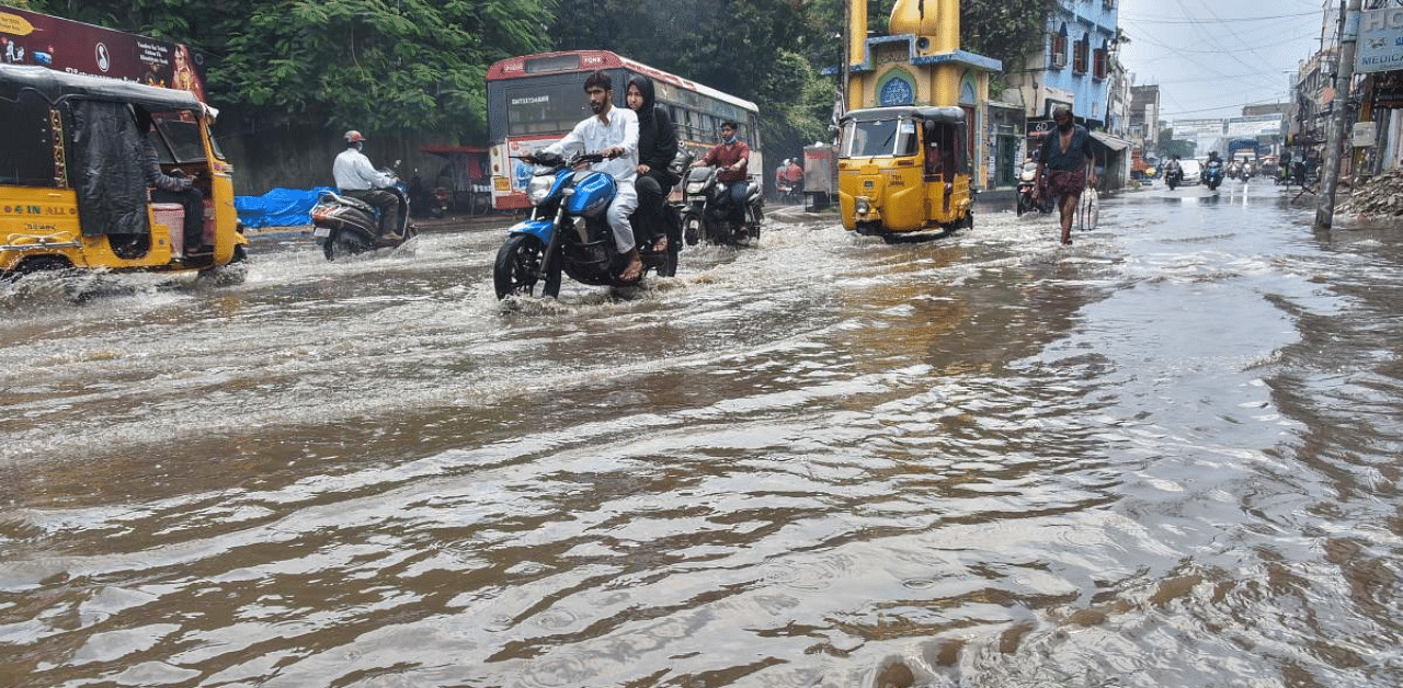  Vehicles ply on a waterlogged street, following continous heavy rainfall, in Hyderabad. Credit: PTI Photo