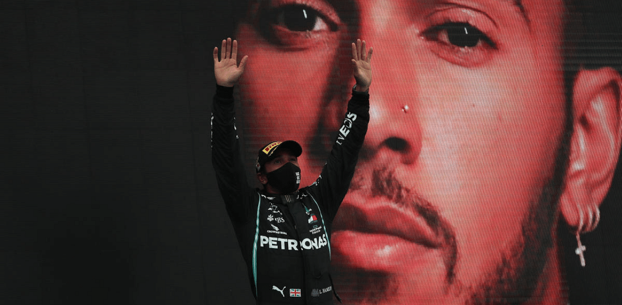 Mercedes' Lewis Hamilton celebrates winning the race on the podium. Credit: Reuters Photo