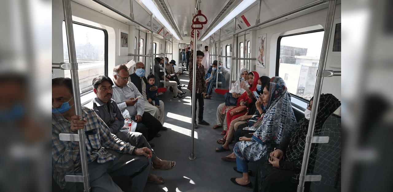 Passengers ride in a newly built Orange Line Metro Train (OLMT), a metro project planned under the China-Pakistan Economic Corridor (CPEC), a day after an official opening in the eastern city of Lahore on October 26, 2020. Credit: AFP Photo