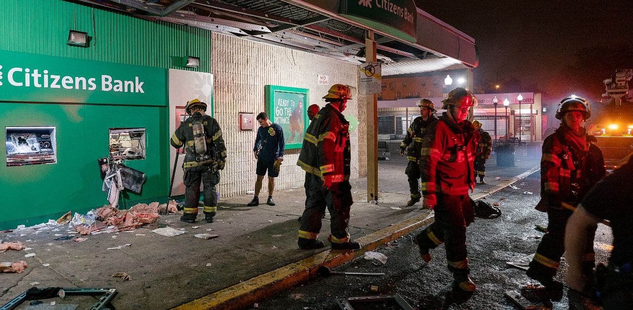 Police officers and firemen respond to a small fire and a broken ATM machine following protests over the police shooting death of Walter Wallace, a Black man in Philadelphia, Pennsylvania. Credit: Reuters