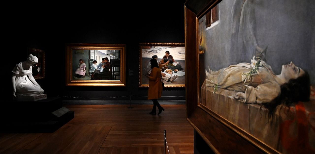 A visitor walks by the painting "Last Dream of a Virgin" by Manuel Villegas Brieva during the exhibition "Uninvited Guests. Episodes on Women, Ideology and the Visual Arts in Spain (1833-1931)" at El Prado museum in Madrid. Credit: AFP