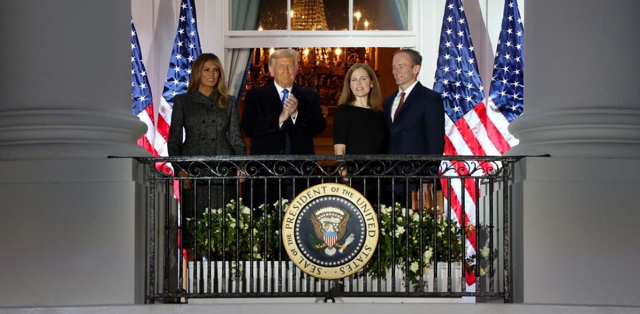US Supreme Court Associate Justice Barrett poses with her husband, Trump and the first lady on the balcony of the White House after taking her oath of office to serve on the US Supreme Court in Washington. Credit: Reuters.
