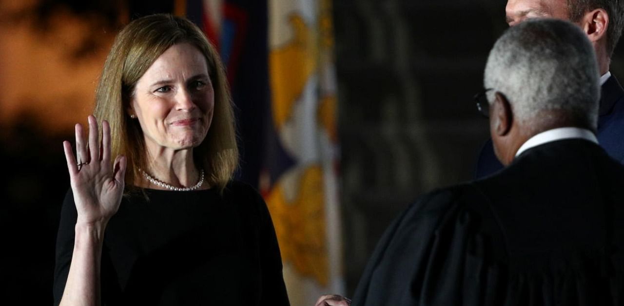 Judge Amy Coney Barrett holds her hand on the Holy Bible as she is sworn in as an associate justice of the US Supreme Court by Supreme Court Justice Clarence Thomas on the South Lawn of the White House in Washington. Credit: Reuters.