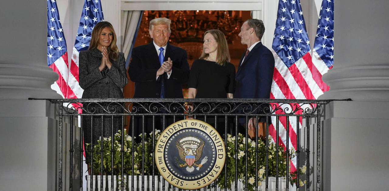 President Donald Trump, first lady Melania Trump, and Amy Coney Barrett and her husband Jesse stand on the Blue Room Balcony after Supreme Court Justice Clarence Thomas administered the Constitutional Oath to her on the South Lawn of the White House White House in Washington. Credit: AP Photo